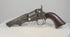 Video of an 1859 Colt Model 1849 Pocket Revolver with an octagonal barrel, aged brass fittings, and a curved walnut grip.