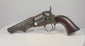Video of an 1859 Colt Model 1849 Pocket Revolver with an octagonal barrel, aged brass fittings, and a curved walnut grip.