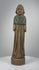 Antique European hand-carved wooden devotional figurine dating to the 18th–19th century, featuring a standing figure with clasped hands, flowing robes, delicately carved garment folds, traces of original green pigment, a naturally aged wooden patina, and minor surface wear characteristic of historic European folk art.