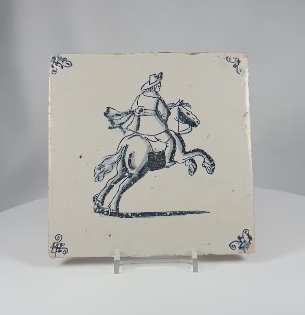 360 degree view of an 18th century Dutch Delft tile with cobalt blue horseman decoration and traditional corner motifs.