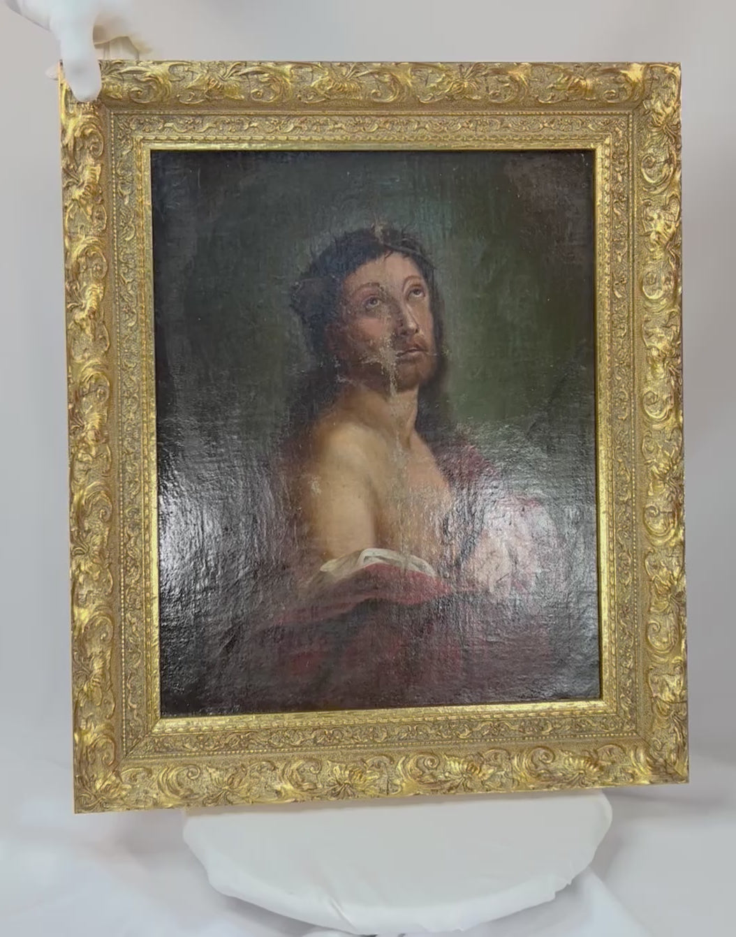 18th-century European oil painting of Jesus Christ crowned with thorns, in crimson drapery with ornate gilt frame.