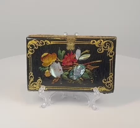 Video showcasing the Victorian black lacquer papier-mâché calling card case with mother-of-pearl floral inlay, gilt decoration, and brass clasp