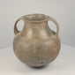 Rotating 360-degree video of an early Etruscan impasto spiral amphora, circa 700–650 BCE, showing its double handles, rounded body, incised spiral decoration, rim, base, and ancient surface patina.