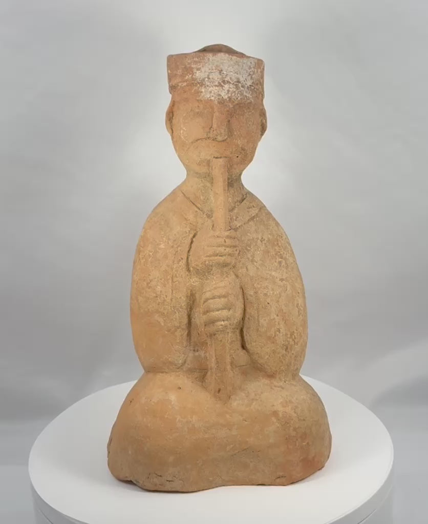 360-degree view of an ancient Chinese Han Dynasty terracotta seated musician playing a long wind instrument, with a tall headdress and surviving pigment.
