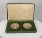 360-degree rotating view of a matched pair of late Victorian to Edwardian colour portrait miniatures, circa 1880–1910 CE, depicting a formally dressed gentleman in a dark suit and a woman in a blue gown with a white lace collar. Both portraits feature gilt-coloured oval surrounds set within a deep green velvet presentation panel, accompanied by a fitted green leather-covered case with cream satin lining and folding easel support. Formerly part of the historic Sears family collection from the estate of Josep