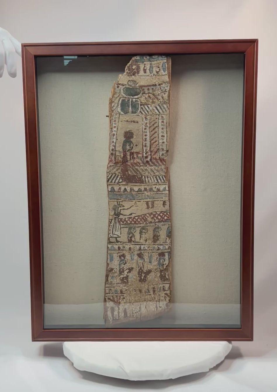 360-degree video of framed ancient Egyptian polychrome coffin fragment showing vivid painted scenes and scarab motif