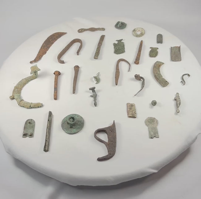 360-degree rotating view of 28 ancient Roman bronze artifact fragments spanning 1st to 12th century AD, showing detailed surfaces, patina, and craftsmanship.