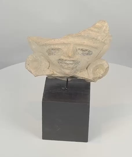 360-degree view of a Pre-Columbian terracotta figural fragment featuring a stylized human face, large earspools, and ceremonial headdress, Mesoamerica, circa 600–1200 CE.