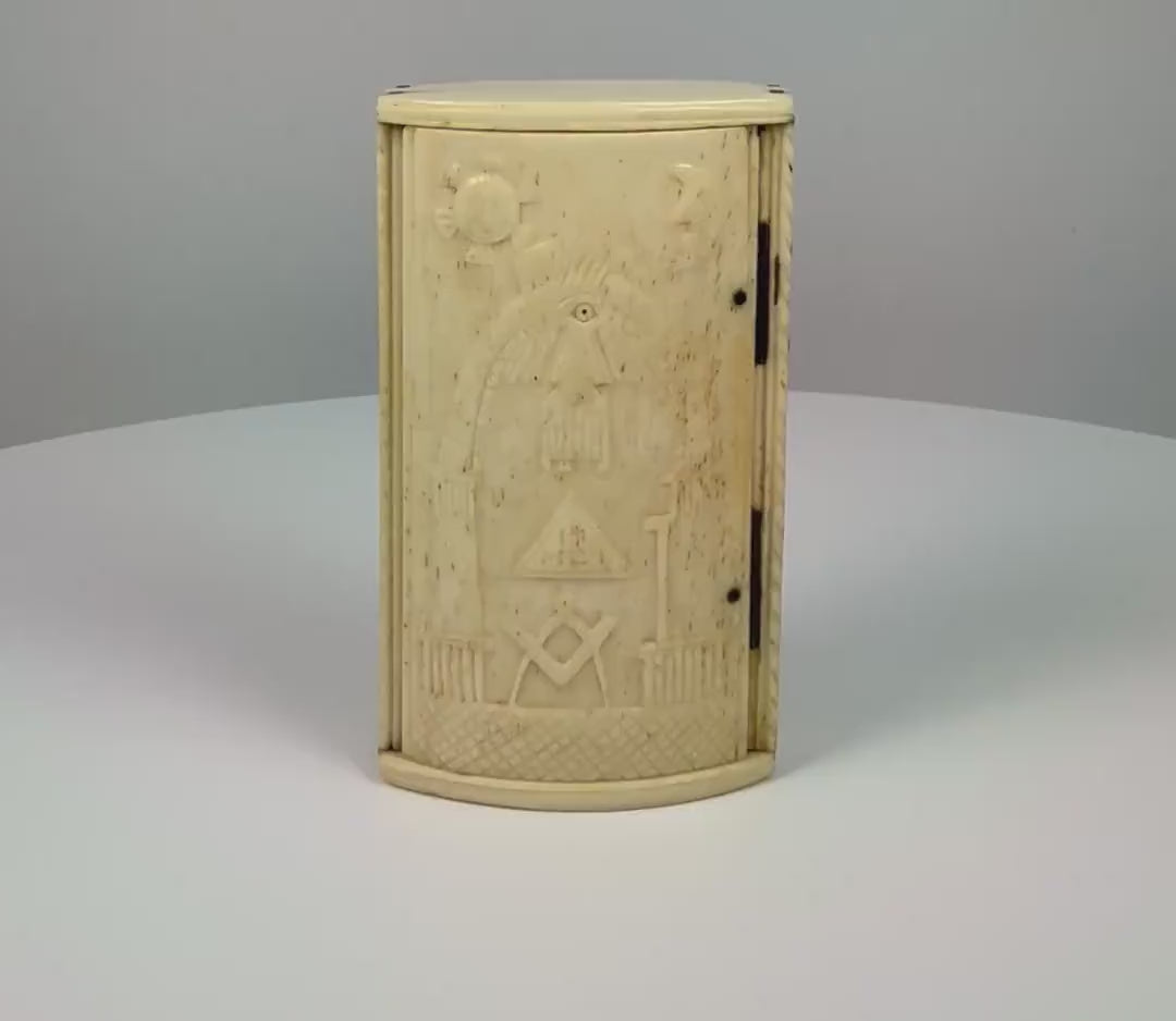 Antique Napoleonic-era bone snuff box attributed to French prisoners of war in Britain, featuring hand-carved Masonic symbols, the Square and Compasses, All-Seeing Eye, Sun and Moon, decorative pillars, rope-pattern borders, an aged patina, and a functional hinged lid with an interior compartment.