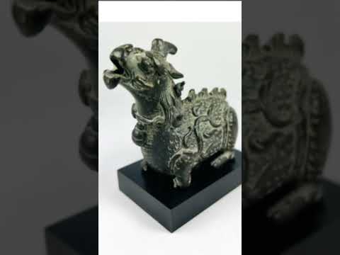 YouTube video showcasing Qing Dynasty bronze Qilin censer rotating  with detailed scale and flame motifs.
