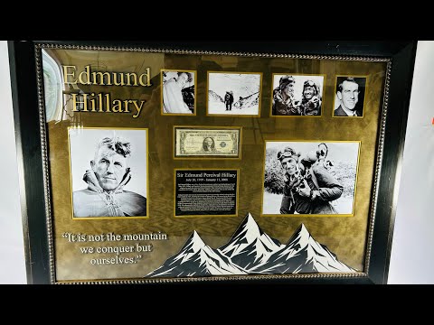 Framed display of Sir Edmund Hillary’s authentic signature on a US $1 banknote, professionally mounted with archival backing and glass, including photographic and illustrative elements commemorating his Everest ascent.