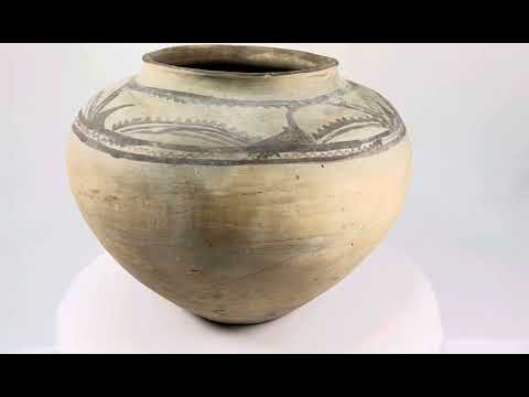 Large Neolithic painted storage jar, circa 5500–4500 BCE, with wide body, narrow rim, and geometric motifs in dark pigment on earthenware surface.