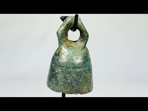 Ancient Roman cast bronze bell, 1st–4th century CE, with suspension loop, rich green patina, and mounted display stand.