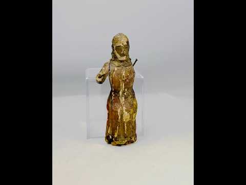 17th-century Spanish Colonial carved wooden figure of a saint with remnants of polychrome paint, expressive facial features, missing one arm, showing age and devotional use.