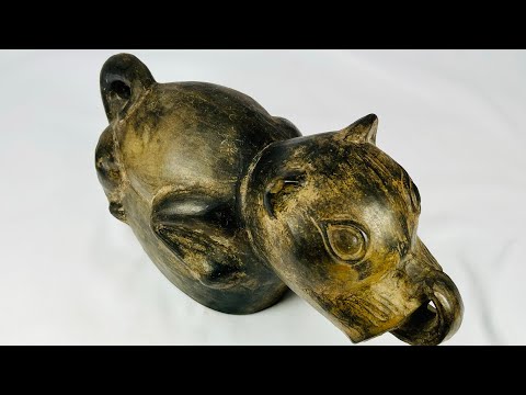 Pre-Columbian Moche stirrup-spouted terracotta vessel from Northern Peru, circa 200–700 AD, shaped as a stylized dog with finely sculpted facial features and dark slip coating. Functional and ritual object symbolizing loyalty and spiritual guidance, reflecting Moche ceramic artistry and cultural traditions.