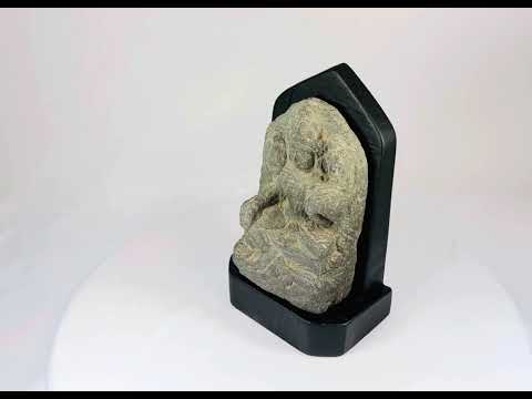 14th-century carved stone stele from West Tibet depicting the Buddhist deity Tara, “Mother of Liberation,” mounted on a black base, showing detailed facial features and traditional iconography, 6 inches tall.