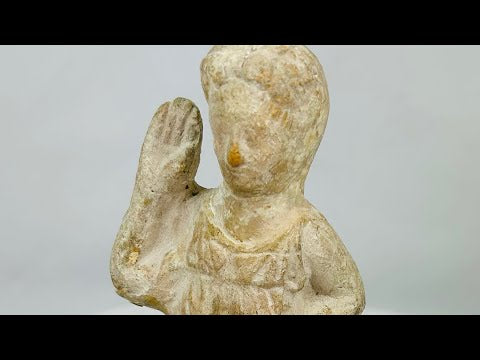 Terracotta figurine of Isis, 1st–3rd century CE, with draped attire, raised hand of blessing, and natural aged patina, blending Egyptian and Roman styles.