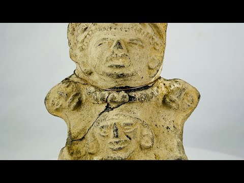 Ancient Pre-Columbian Veracruz ceramic effigy depicting two joined human figures, hand-modeled with stylized facial features and incised details, tan clay with surface wear and encrustation, dating to circa 300 BCE–600 CE, representing Mesoamerican ritual and symbolic artistry.