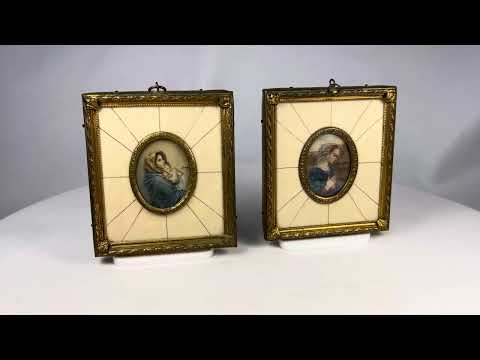 Pair of 19th century hand-painted miniature portraits in gilt frames with ivory-style panel insets. Depicting devotional female figures, one in prayer and one cradling a child. Original rectangular frames with oval portrait centers, fine detail and patina.