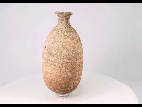 Ancient Greco-Roman terracotta storage amphora, circa 1st–3rd century CE, tall vessel with narrow neck and aged earthen patina.