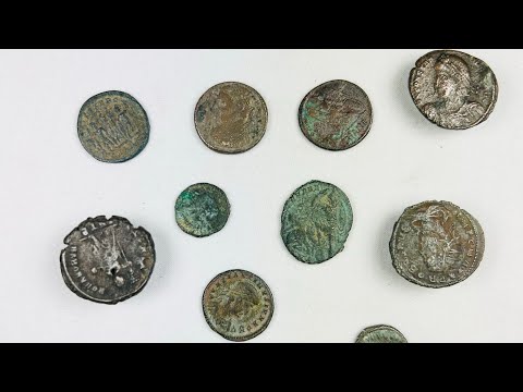 Collection of 12 ancient Roman bronze coins, varying in size and condition, featuring worn imperial busts and reverse imagery; authentic hoard of currency from the Roman Empire with patinated surfaces and archaeological character.