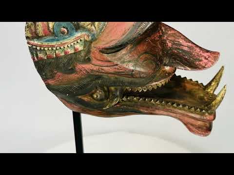Video presenting a late 19th-century Javanese Cakil mask, a carved wooden demon figure used in traditional Wayang Topeng dance theatre, featuring original polychrome pigments and expressive mythological detailing.