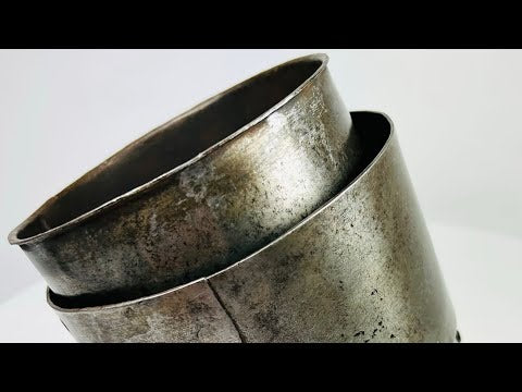 17th-century European siege armour arm guard, crafted from metal with riveted construction and aged patina from historic use.