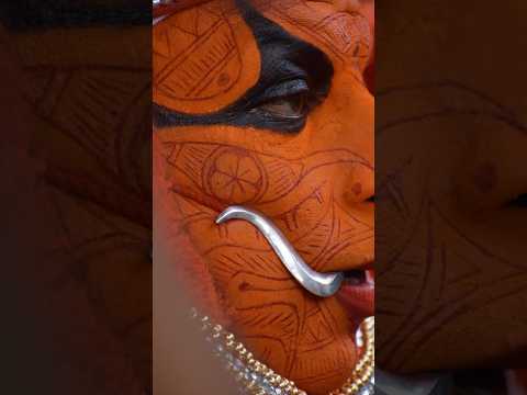Video showing traditional facial markings and a curved ceremonial blade, relating to the Indonesian Dayak knife.