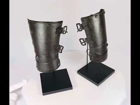 Pair of 14th–15th century European steel vambraces with three articulated plates, raised ulna bosses, and adjustable leather buckles, used for forearm protection in battle or tournaments.