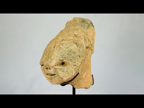 Ancient Bura culture terracotta head from Niger, West Africa, circa 300–1100 CE. Stylized lips, flat nose, and subtle rear ornamentation with natural patina. Likely created for ceremonial or funerary purposes, reflecting the symbolic, abstract artistry and spiritual traditions of early West African societies.