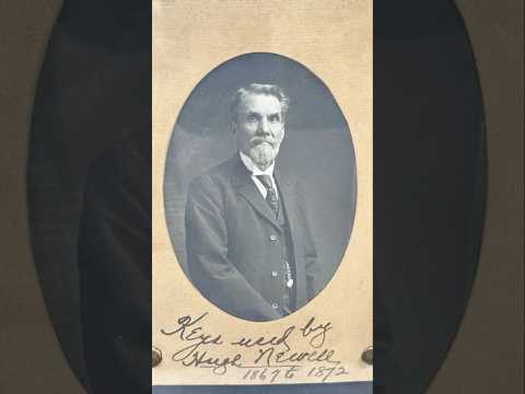 Framed 19th-century display with eleven iron keys, portrait of night watchman Hugh Newell, and early photograph of T. McCormick’s 1867 factory, preserved in a wooden shadowbox.