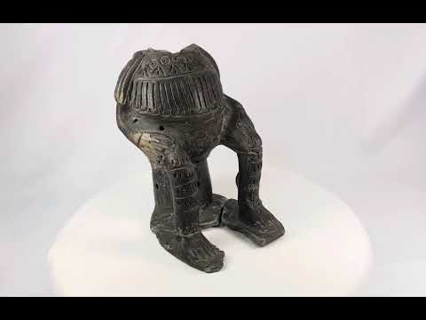 Terracotta figure in Chupicuaro style from West Mexico, mid-20th century, with hollow body, geometric incised motifs, pierced vent holes, and surface patina. A reproduction inspired by ancient Mesoamerican funerary and ceremonial sculpture.