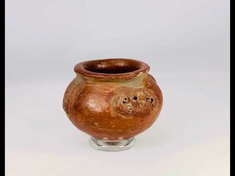 A late Pre-Columbian terracotta vessel with sculpted handles, ornamental motifs, and earthy red patina, dating to circa 1000–1500 CE.