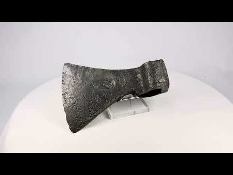 Medieval forged iron axe head, 12th–15th century CE, with curved blade for chopping, flat poll for hammering, and visible etched markings; weathered patina and surface pitting from centuries of use.