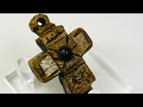 Video showing a Middle Byzantine carved bone pectoral cross with incised motifs, central raised boss, and aged patina