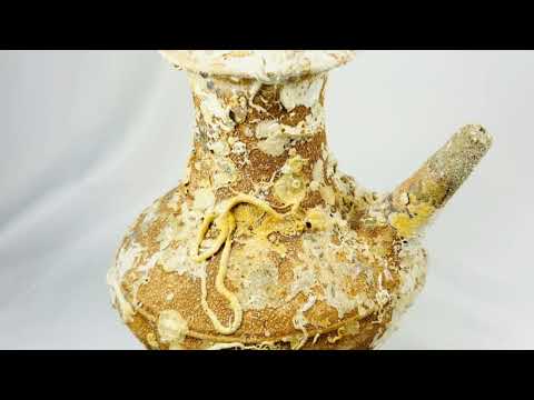 Song Dynasty Chinese terracotta wine pot with marine encrustations, recovered from a shipwreck near Balabac Island, featuring a wide mouth, rounded body, and slender spout, reflecting ancient maritime trade and centuries underwater.