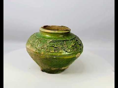 Han Dynasty green-glazed pottery vessel with molded relief figures of humans and animals, funerary mingqi, ancient China, circa 202 BCE–220 CE.