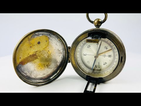 Rotating video of a French brass pocket compass with hinged lid and working sighting lens, early 20th century.