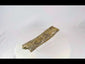 Fossilized theropod dinosaur bone from the Cretaceous Period, approximately 11 inches long, collected in Wyoming, USA, showing natural mineralization and preserved surface texture.