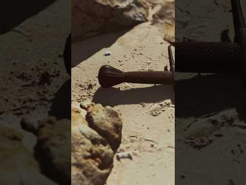 Archaeologists uncover ancient short sword partially buried in desert excavation site — real historical weapon discovery featured by Relic and Rarity.