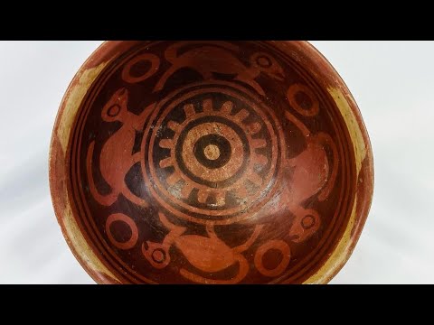 Terracotta Nariño culture bowl from Colombia and Ecuador, decorated with bichrome slip, negative resist geometric border, and four monkeys in the interior, dating from 800–1500 CE.
