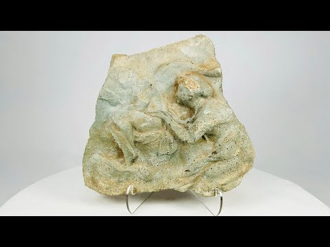 Ancient carved limestone relief fragment from the Mediterranean or Near East, Classical Period (circa 500 BCE–500 CE). Features two expressive human figures, likely part of a larger mythological or commemorative scene. Weathered surface and patina reflect centuries of age and Classical artistic traditions.