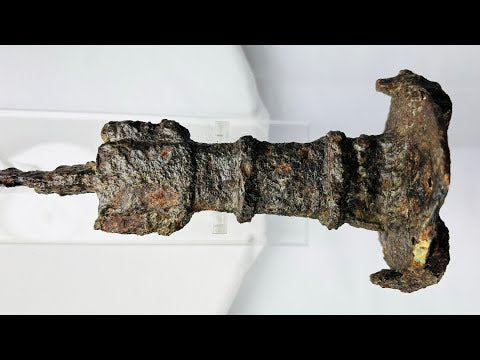 Ancient Luristan iron short sword from Western Iran, circa 750–650 BCE, featuring a lion-head disc pommel, ribbed grip, and straight double-edged blade. Iron Age weapon with natural patina and surface oxidization, reflecting Luristan metallurgical skill, ceremonial significance, and martial artistry.