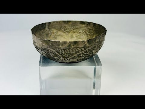 360° view of a 12th–13th century Seljuk Persian silver unguent bowl, intricately engraved with floral and geometric motifs, showcasing its detailed craftsmanship, aged patina, and historical artistry under studio lighting.