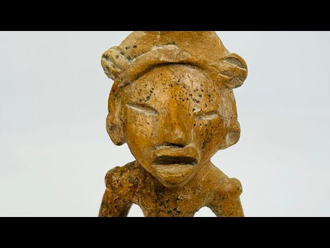 Ancient West Mexican terracotta figure fragment with headdress and expressive open mouth, dating 300 BCE–300 CE, mounted on a museum-style display stand.