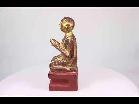 Hand-carved Burmese wooden monk statue, 18th–19th century, with gold leaf and red lacquer, kneeling in prayerful devotion.