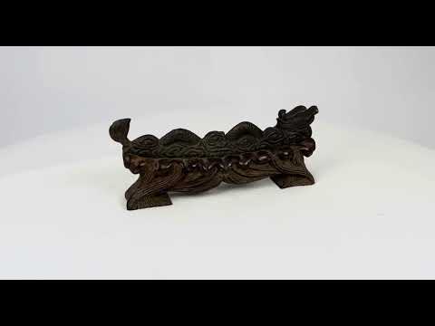 Chinese bronze incense holder depicting a coiled dragon with archaic motifs, mounted on a hand-carved hardwood base shaped like clouds or flames, showing patina and minor surface oxidation, circa 1900–1930, Late Qing to Early Republic Era.