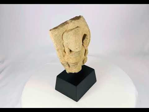 360 video of carved stone fragment of Padmapani (Avalokitesvara) from 12th-century Khmer Empire, Cambodia, showing serene facial features and flowing contours, mounted for display.