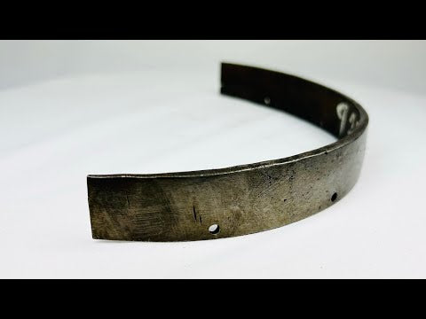 17th-century European siege armour forged steel band, curved protective element with rivet holes and aged patina from historic use.