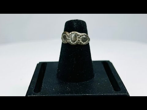 Ancient Late Roman–Byzantine silver ring featuring a clustered bezel of three oval motifs with natural aged patina, circa 300–600 CE.